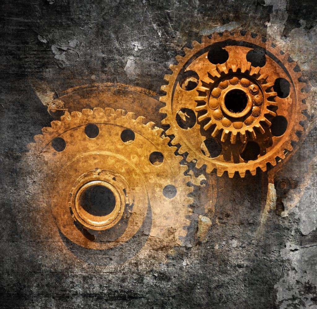 Rusty gears on a textured, industrial background.