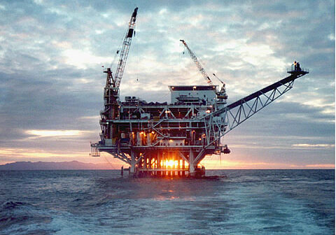 Ocean oil rig picture at sunset
