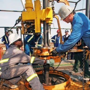 Men working on oil drill with VCI corrosion prevention